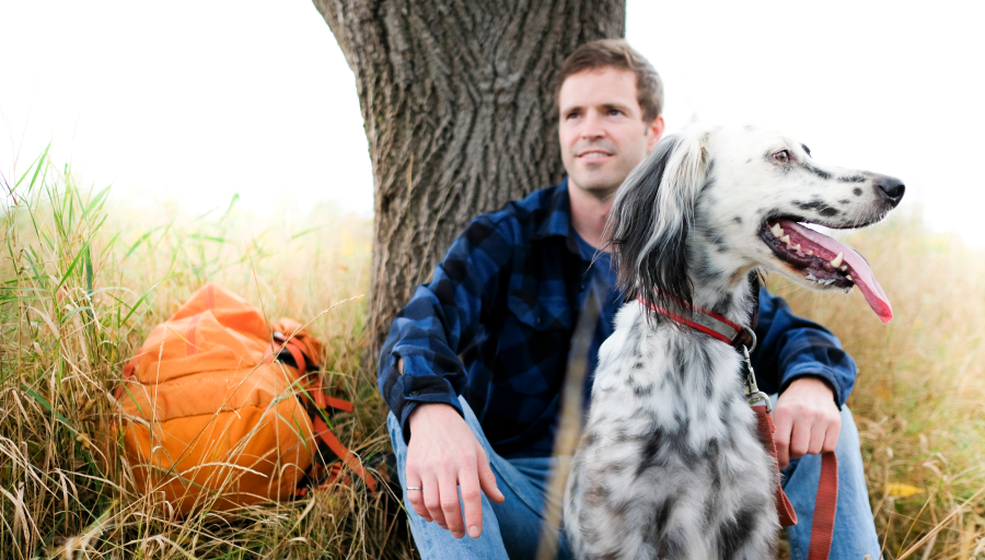 A person sitting next to a dog