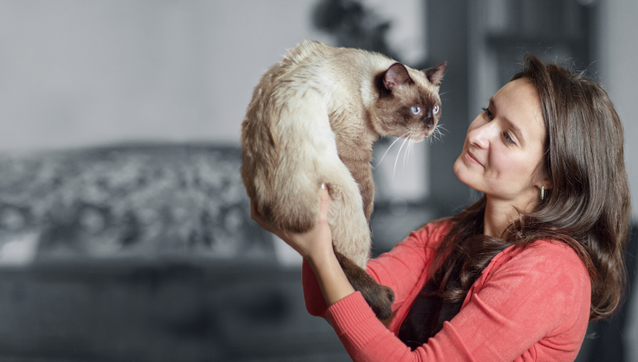 A woman holding a cat