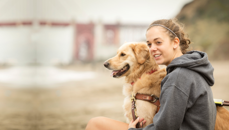 A woman sitting with a dog